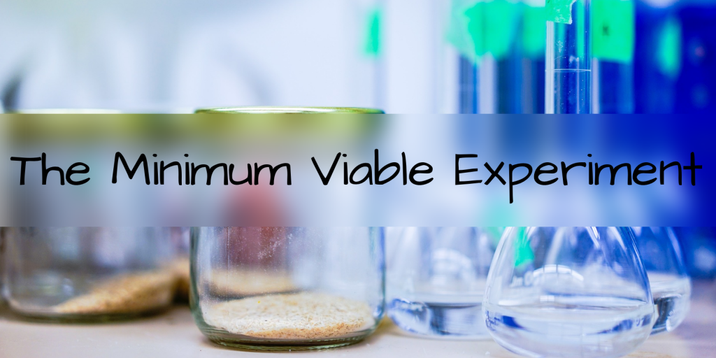picture of beakers and experimental jars with the words "the minimum viable experiment" written over top